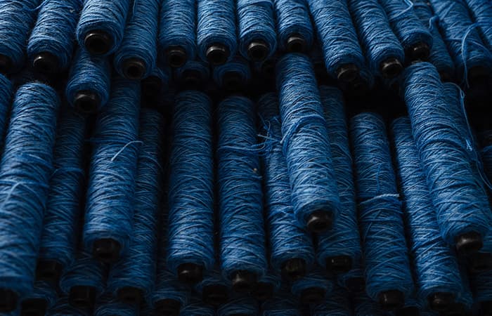 Craftsman inspecting a carpet on the loom