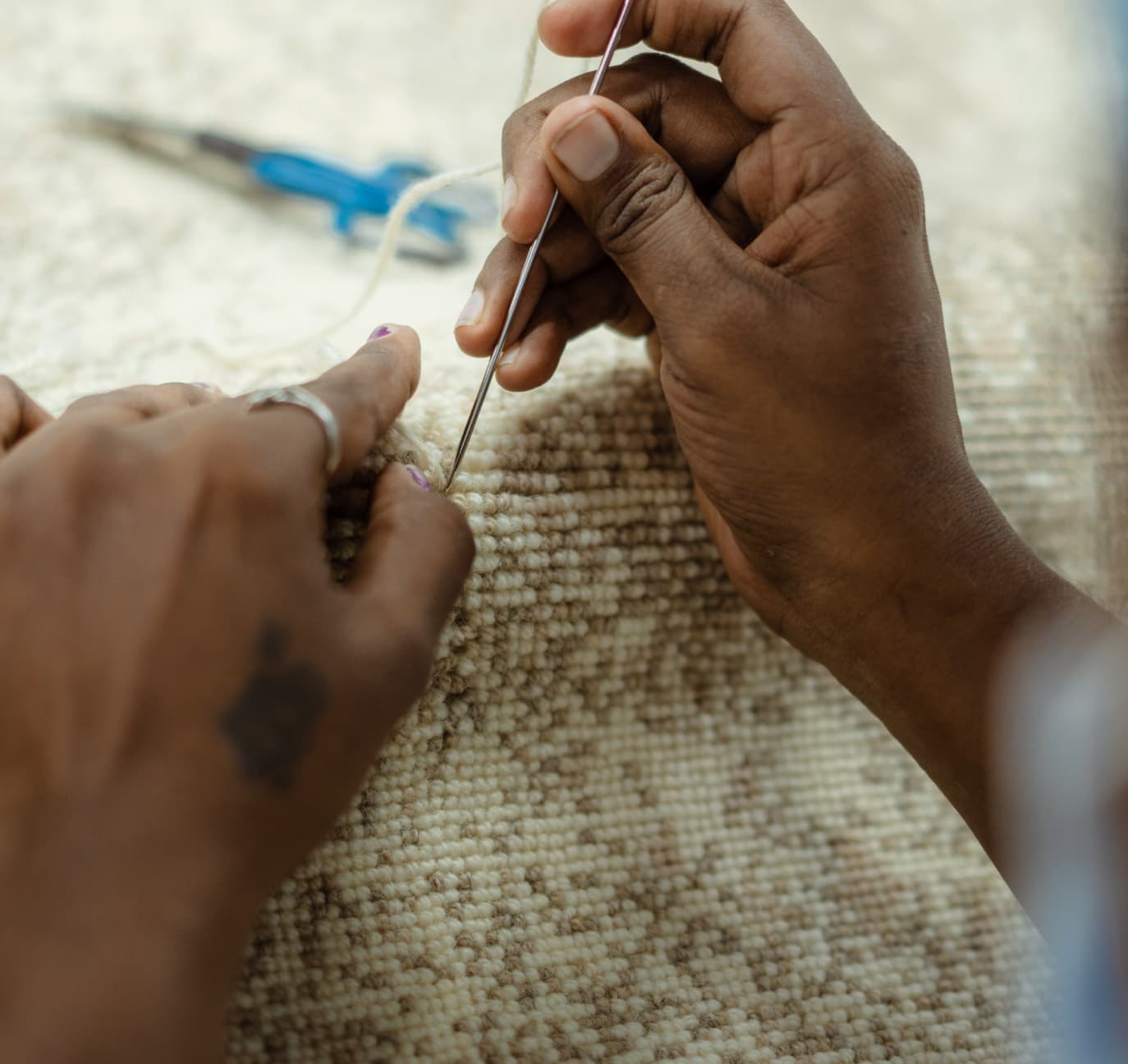 Artisan hand-finishing a woven carpet